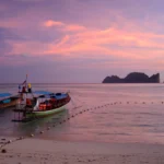 Tour boats moored at sunset on Koh Phi Phi Don