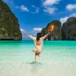 Traveler standing in shallow water at Maya Bay in the Phi Phi Islands